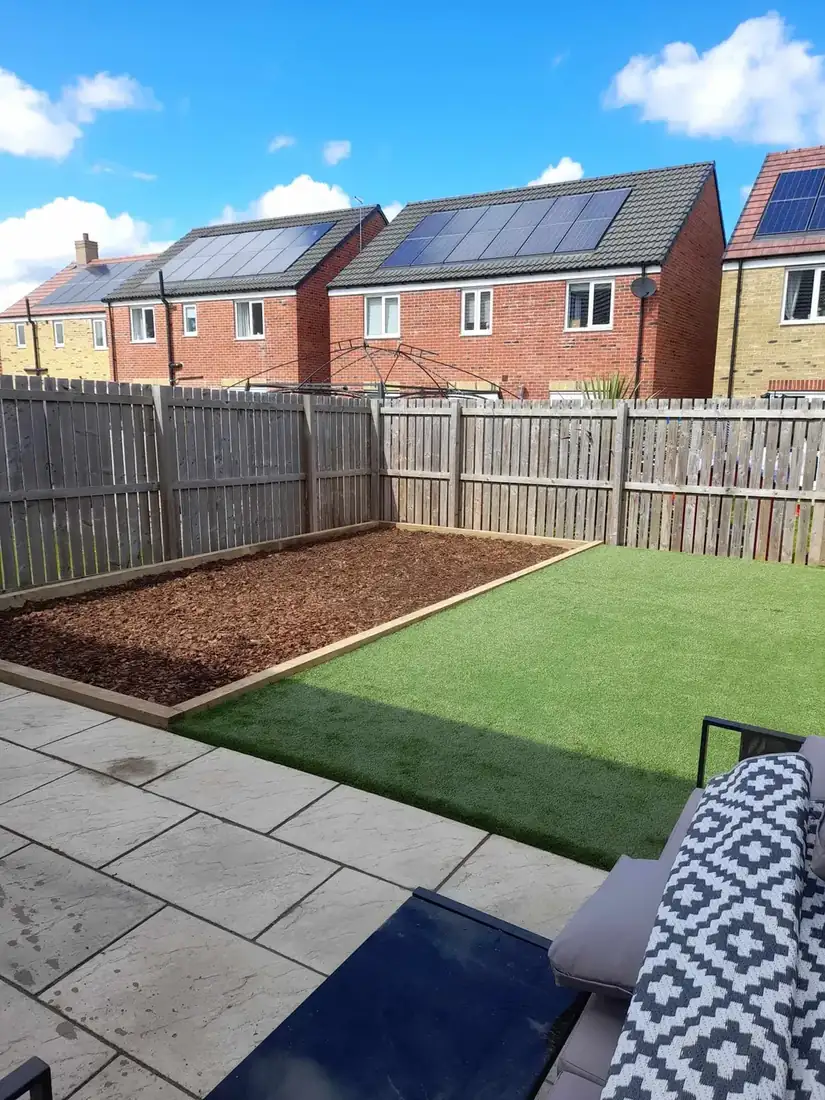 Riven slabbed patio with lawn & bark border